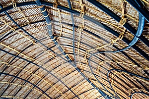 Beautiful thatched roof surface detail of mixed materials pattern structure by weave pile straw with steel bars.