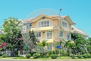 Beautiful three-story house with palm trees, trees