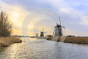 Beautiful three windmills in a Dutch winter landscape