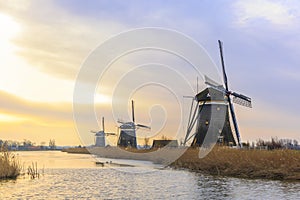 Beautiful three windmills in a Dutch winter landscape