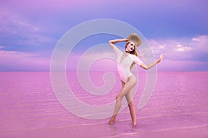 Beautiful top model posing in pink lake