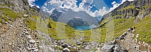 Beautiful top view of Oeschinensee, Oeschinen Lake by Kandersteg, Switzerland. Turquoise lake with steep mountains and rocks in ba