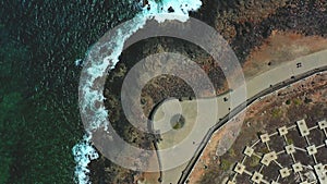 Beautiful top view of seashore, waves breaking into the rocks.