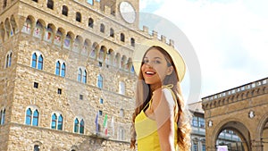 Beautiful tourist girl in Florence with Palazzo Vecchio palace