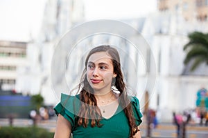 Beautiful tourist girl at the Ortiz Bridge with La Ermita church on background in the city of Cali in Colombia photo