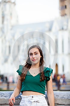 Beautiful tourist girl at the Ortiz Bridge with La Ermita church on background in the city of Cali in Colombia photo