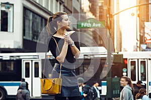 Beautiful tourist girl traveling and enjoying busy city life of New York City.