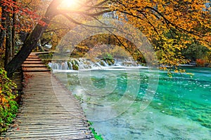 Beautiful tourist pathway in colorful autumn forest, Plitvice lakes, Croatia