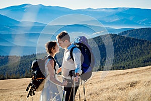 Beautiful tourist wedding couple hugs on the top of mountain. Honeymoon in Alps