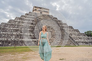 Beautiful tourist woman observing the old pyramid and temple of the castle of the Mayan architecture known as Chichen