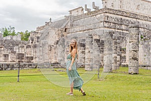 Beautiful tourist woman observing the old pyramid and temple of the castle of the Mayan architecture known as Chichen