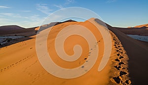 Beautiful towering red sand dunes at famous Deadvlei near Sossusvlei in Namib desert, Namibia, Southern Africa