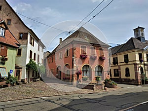 The beautiful town of Westhalten with town hall, fountain and cobblestone street