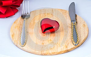 Beautiful toy heart lies on a chopping board