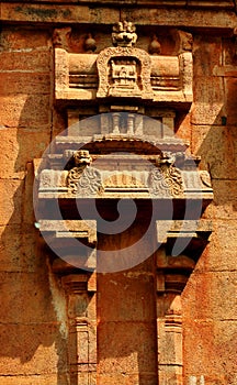Beautiful traditional architecture design on the stone tower wall in the ancient Brihadisvara Temple in Thanjavur, india.