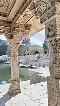 Beautiful traditional building from white carving at lake. Raj