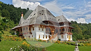 Beautiful traditional house in monastery courtyard. Maramures, Romania