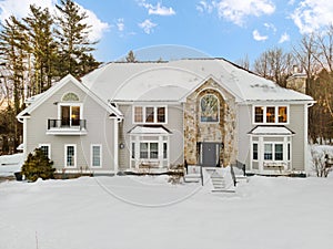 Beautiful, traditional white house in a winter countryside setting in New England