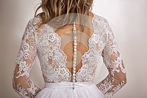 A beautiful traditional white wedding dress detail with buttons on the back
