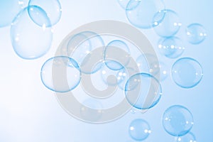 Beautiful Transparent Blue Soap Bubbles Floating in The Air. Blue Textured Gradient Blurred Background