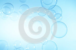 Beautiful Transparent Blue Soap Bubbles Floating on White Background.