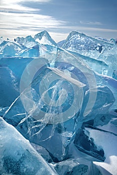 Beautiful transparent ice block with cracked structure on ice field background