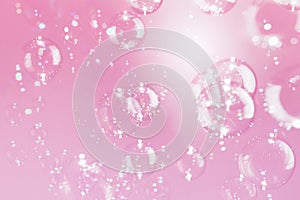 Beautiful Transparent Shiny Soap Bubbles Floating on Pink Background. Celebration Festive Backdrop. Pink Textured.