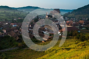 Beautiful Transylvanian saxon village and fortified church in morning sunlight