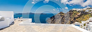 Beautiful travel background, two white chairs with white architecture on Santorini island, Greece. Luxury couple destination