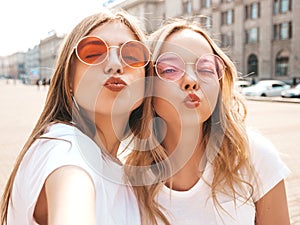 Beautiful trendy girls posing in the street