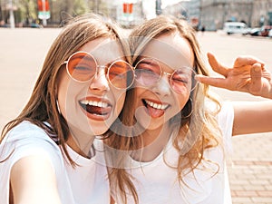 Beautiful trendy girls posing in the street