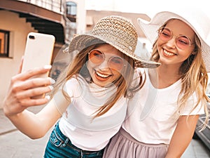 Beautiful trendy girls posing in the street