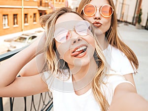 Beautiful trendy girls posing in the street