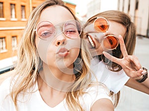 Beautiful trendy girls posing in the street