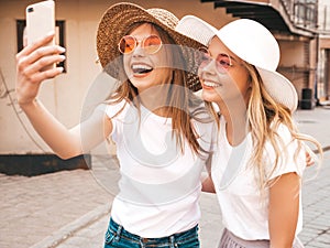 Beautiful trendy girls posing in the street