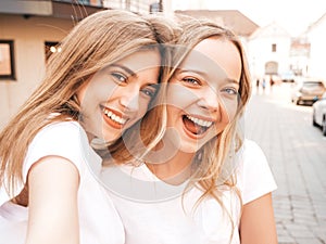 Beautiful trendy girls posing in the street