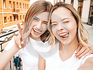 Beautiful trendy girls posing in the street