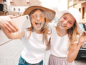 Beautiful trendy girls posing in the street