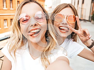 Beautiful trendy girls posing in the street