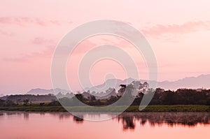 Beautiful tranquil river scene in evening or morning with warm s