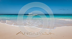 Beautiful tropical beach. Anguilla written in white sand.