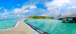 Beautiful tropical beach with bungalos panorama view at Maldives