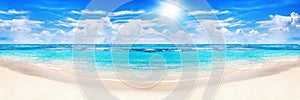 Beautiful tropical beach panoramic view, turquoise sea water, ocean waves, yellow sand, sun blue sky white clouds, summer holidays