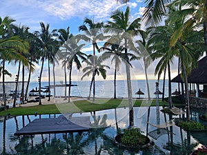 Beautiful tropical beach and sea with umbrella and chair around swimming pool in hotel resort