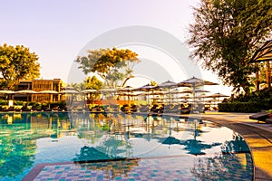 Beautiful tropical beach and sea with umbrella and chair around swimming pool in hotel resort for travel and vacation