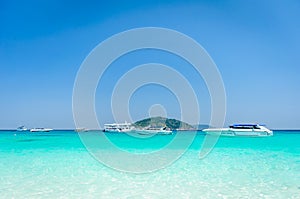 Beautiful tropical beach, white sand and blue sky background wit