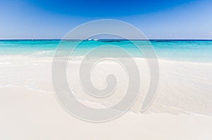 Beautiful tropical beach, white sand and blue sky background wit