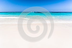 Beautiful tropical beach, white sand and blue sky background wit