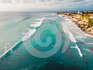 Beautiful tropical coastline with turquoise ocean and waves in Bali. Aerial view