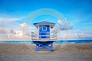 Beautiful tropical Florida landscape with blue lifeguard house at sunset twilight. American beach ocean scenic nature view with